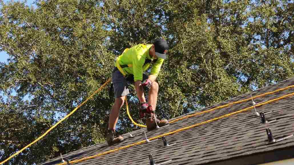 Raze Solar contractor on roof wondering do solar panels increase home value in Florida