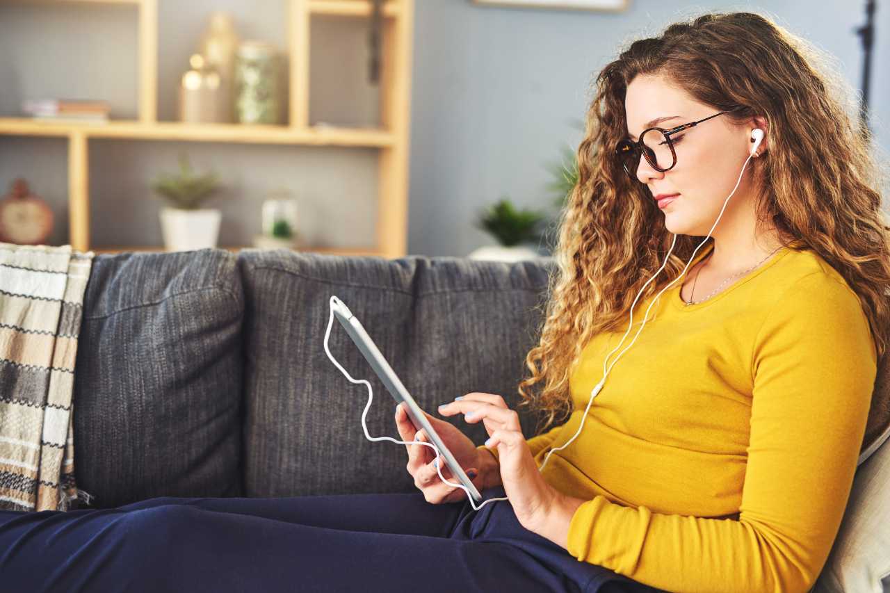 woman on computer downloading solar panel monitoring app