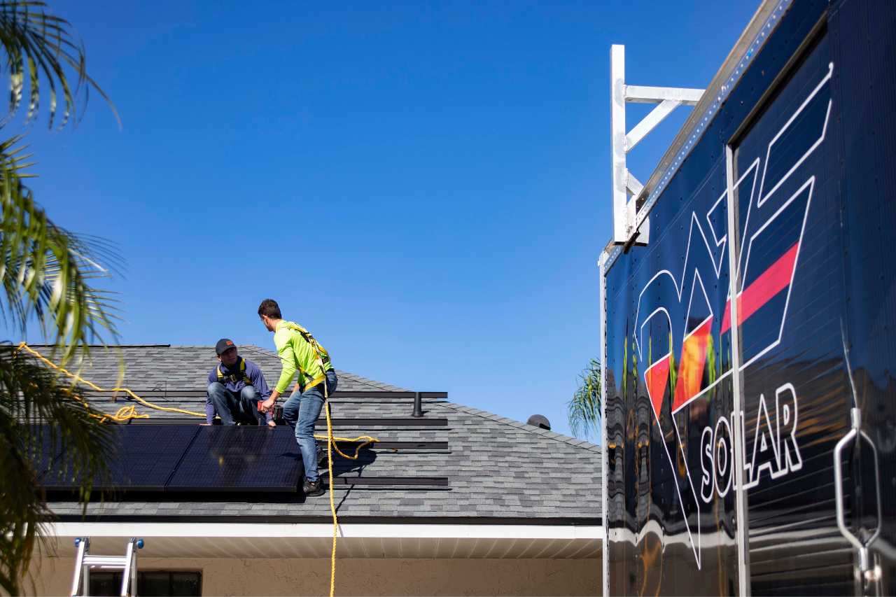 solar energy company on roof installing rooftop solar panels