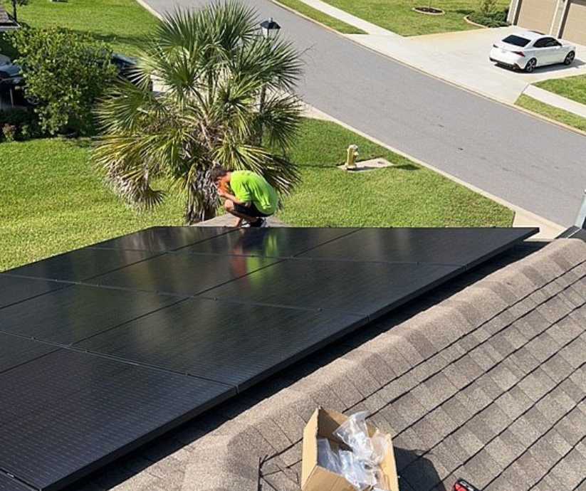 solar panel installer working on home energy system
