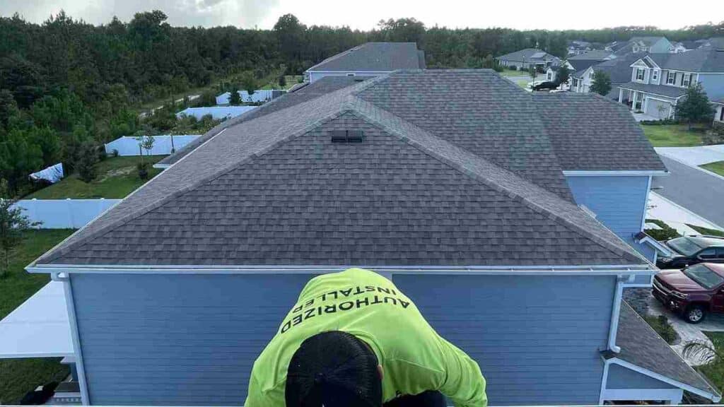 Florida solar installer working on residential shingle roof to install new solar panels