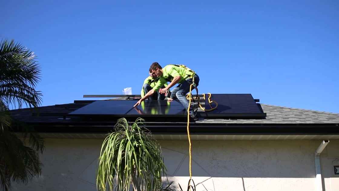 solar energy company installing new rooftop solar panels on shingle roof in Florida