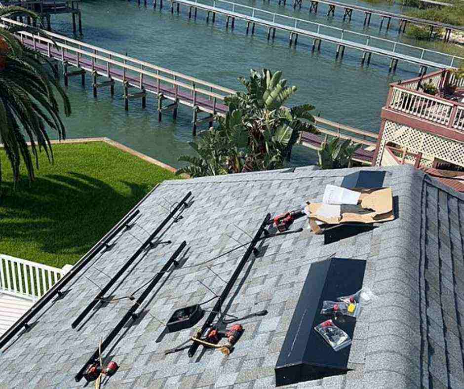 solar installer adding roof mounting brackets to hold solar panels to roof