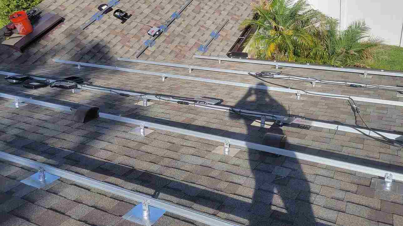 Florida solar company installing solar panel brackets on roof of homeowner with JEA power company