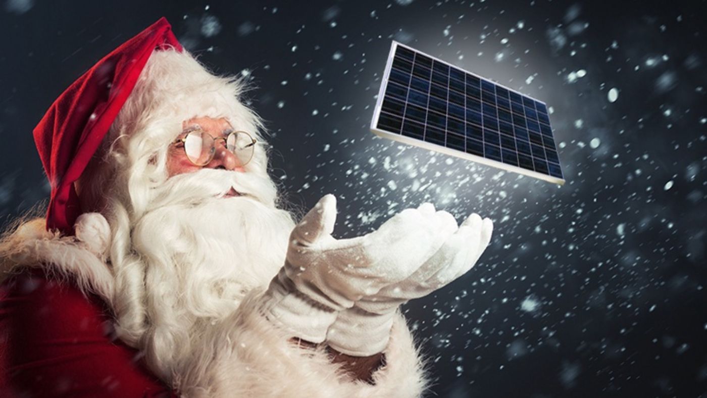 Santa holing solar panel and giving as Christmas gift