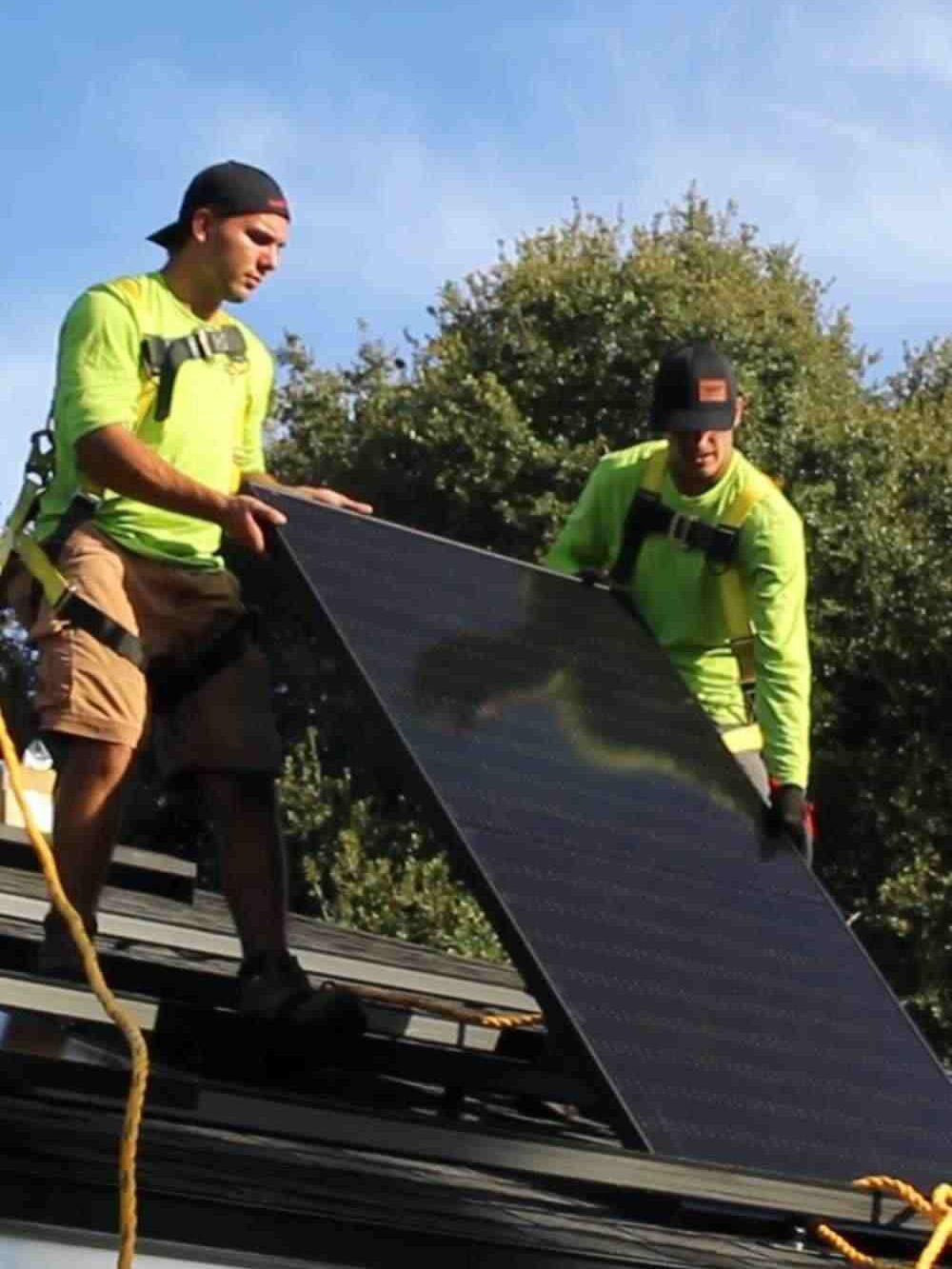 two contractors completing solar panel installation job in Jacksonville, FL in 2022
